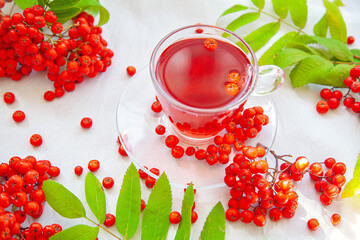 a mug of tea with red mountain ash