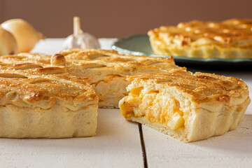 Brazilian Chicken Pie -  Homemade Chicken Pie on Spatula on a Wooden Table Rustic Appeal