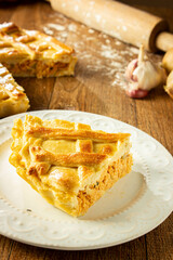 Brazilian Chicken Pie -  Homemade Chicken Pie on Spatula on a Wooden Table Rustic Appeal