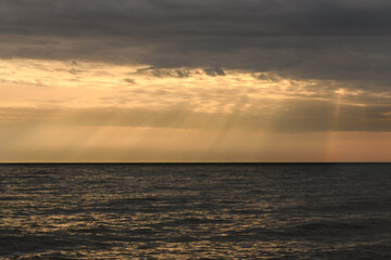 Cloudy sunset over Baltic Sea. Looks like rays from heaven