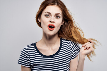 pretty woman in a striped t-shirt gesture with his hands model studio