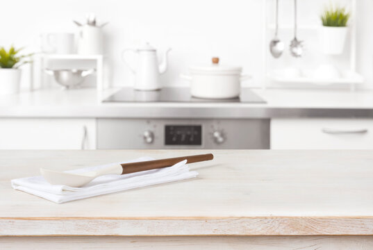 Cooking spoon and napkin on table with blurred kitchen background