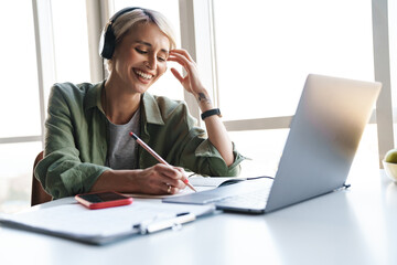 Middle aged blonde woman with short hair studying