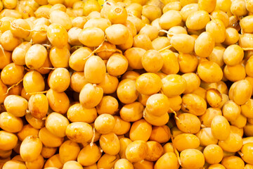 fresh yellow fruits of date palms at the market in Hurghada, Egypt