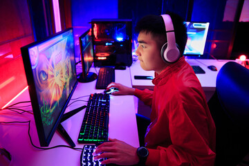 Asian gamer playing online game on PC in dark room. e-Sport Games compilation