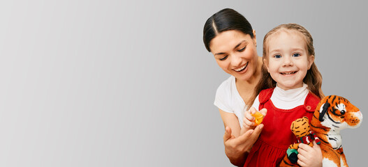 Child psychologist with little girl having fun during a psychotherapy session. Care of children's mental health