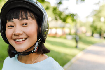 Close up of a smiling young asian woman