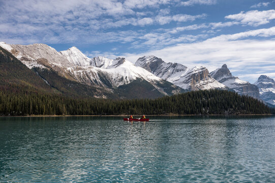 Tourists canoeing into the Spirit Island on Maligne lake at Jasper national park, Canada