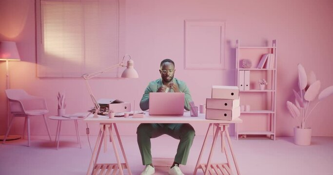 Elegant black gentleman man is burned out at his work routine in pink office monochrome design stop working closing laptop crypto down after bad news and fatal mistake desition of investment exhausted