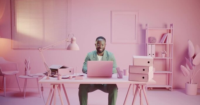 Black happy startupper business man or startup creator is smiling happy at work office with monochrome design working hard in pink pastel room studio monocolor creative office with monochrome design