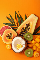 Naklejka na ściany i meble Set of exotic fruits on orange background