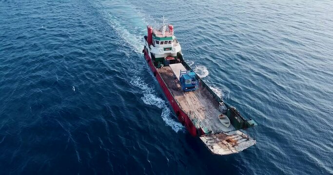 Aerial view of barge transporting single truck. High quality 4k footage
