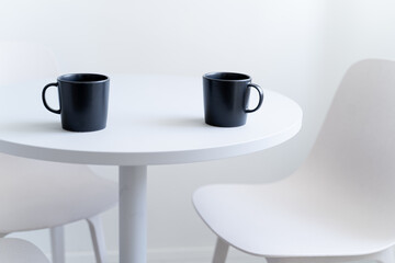 Coffee mugs on a white simple table