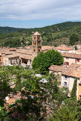 View on mountains cliff, old houses, green valley in remote medieval village Moustiers-Sainte-Marie...