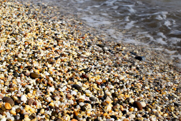 Natural texture background, colorful sea stones in water, top view