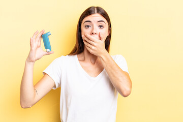 young hispanic woman covering mouth with hands with a shocked. asthma concept
