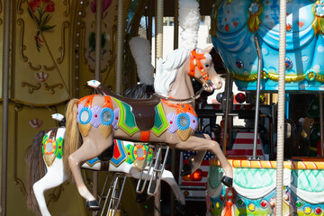 Fototapeta na wymiar Colorful horse on traditional old french caroussel in city park