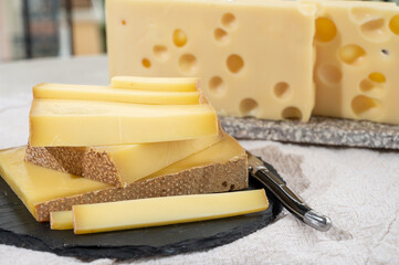 Cheese collection, hard French cheeses comte and emmentaler with round holes made from cow milk