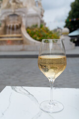 Drinking of brut champagne sparkling wine in street cafe in old central part of city Reims, Champagne, France