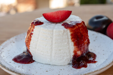 Cheese collection, white Italian soft cheese ricotta served as sweet dessert with homemade plum jam