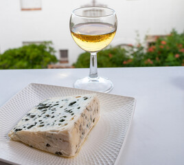 Cheese collection, semi-hard French blue cheese roquefort from Roquefort-sur-Soulzon, France served with sweet cold white french wine