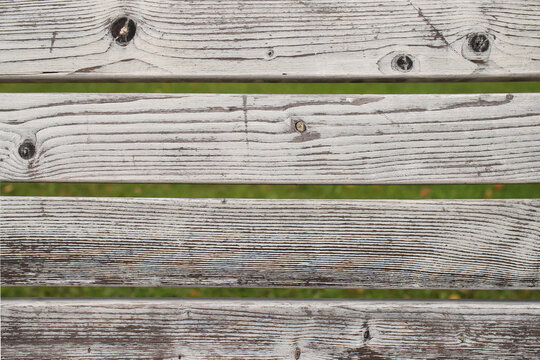 parallel lines of textured wooden slats of a park bench