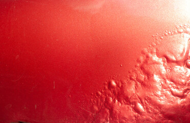 Corroded metal texture from an old car. Grunge texture in red.