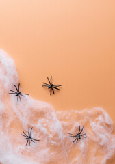 Halloween scary background with spiders and spider web. Minimal Halloween concept. orange color background. vertical image