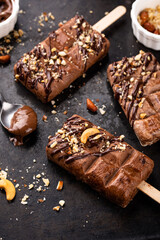 Chocolate ice cream popsicle with nut