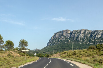 Road with the Pic de Saint-Loup, emblematic mountain of the French city of Montpellier, France