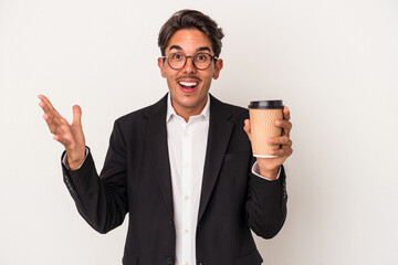Young mixed race business man holding take away coffee  isolated on white background receiving a pleasant surprise, excited and raising hands.
