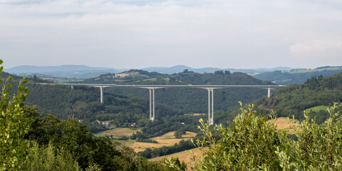 Bridge in beautiful valley, typical french countryside with mountains and forest, France, Europe