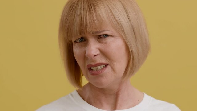 Closeup Portrait Of Disgusted Senior Woman Looking At Camera And Frowning Face