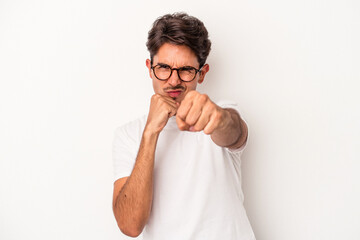 Young mixed race man isolated on white background throwing a punch, anger, fighting due to an argument, boxing.