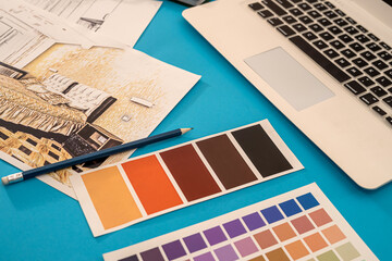 on the background are laid out drawings of the house with a compass, pencil, and colored palette