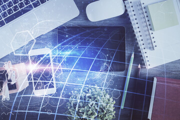 Double exposure of map hologram drawing over desktop. Top view. International connection concept.