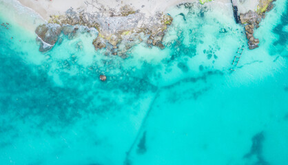 Aerial view of sandy beach and ocean with small waves in Cancun, Mexico. Top view from drone. Playa...