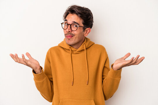 Young mixed race man isolated on white background doubting and shrugging shoulders in questioning gesture.