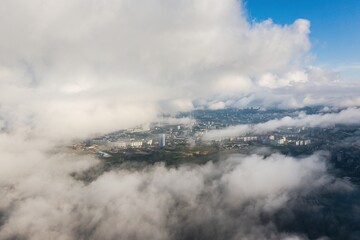 An epic drone view of Vladivostok in cloudy weather with low cinematic fog