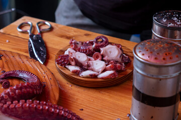 Cooked octopus tentacles for the preparation of a ration of pulpo a feira (octopus)