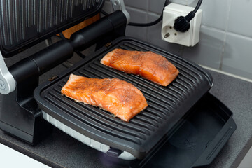 Trout fillet on an electric grill. Healthy food. Food preparation process. Homemade food. Photo