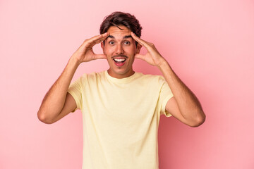Fototapeta premium Young mixed race man isolated on white background receiving a pleasant surprise, excited and raising hands.