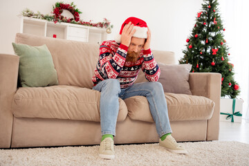Full size photo of stressed depressed unhappy guy hate new year christmas have problem trouble sit sofa thinking