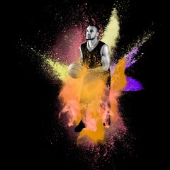 Fototapeta premium High jumping. Young man, a male basketball player in explosion of colored powder