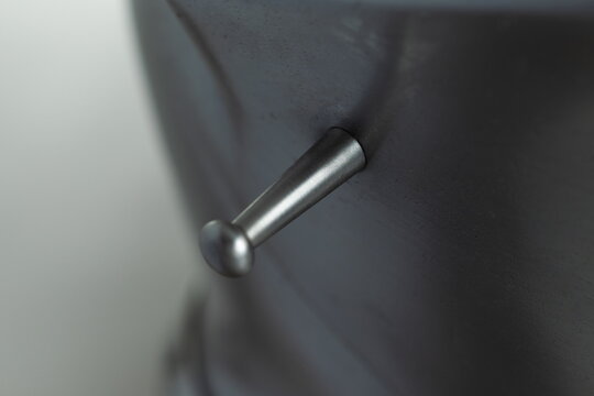 Medieval knightly Milanese helmet with a heraldic kleinod in the form of a swan and a crown, period of the 15th century, on a light background.