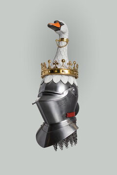 Medieval knightly Milanese helmet with a heraldic kleinod in the form of a swan and a crown, period of the 15th century, on a light background.
