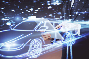 Double exposure of man's hands holding and using a digital device and automobile theme hologram...