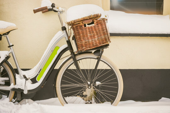 Dutch bicycle with basket covered with snow during wintertime