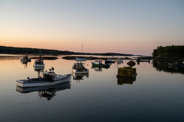 Maine Lobster Boats Moored in a Harbour of Calm Water with a Floating Deck Full of Lobster Traps 