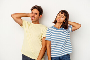 Fototapeta premium Young mixed race couple isolated on white background tired and very sleepy keeping hand on head.